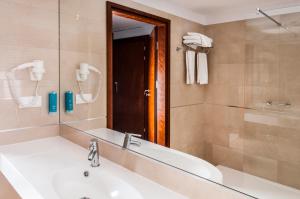 a bathroom with a sink and a mirror at Grand Lubicz Uzdrowisko Ustka in Ustka