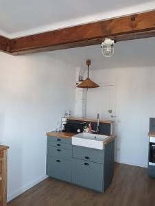 a kitchen with a sink and a counter at Escapade de charme les pieds dans l'eau in Houlgate