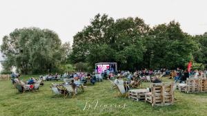 a crowd of people sitting in lawn chairs watching a stage at L'Oiseau De La Cathédrale - Calme - Jardin - Wifi in Troyes