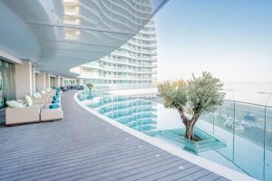 a hotel hallway with a pool and a building at Limassol Del Mar in Limassol
