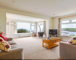 a living room with two couches and a television at Sea Mist in Polzeath