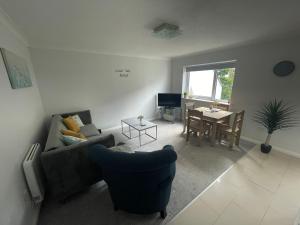 a living room with a couch and a table at Canal Side Retreat - 2 Bedroom Apartment in Heybridge