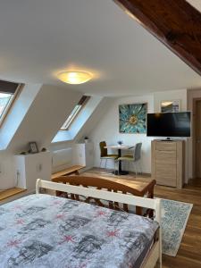 a attic room with a bed and a dining room at KronSoul in Braşov