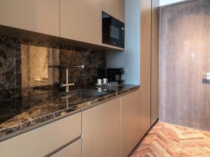 a kitchen with a sink and a counter at Limassol Del Mar in Limassol