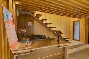 an office with a staircase in a room with wooden walls at Mystic Valley Spa Resort, Igatpuri in Igatpuri