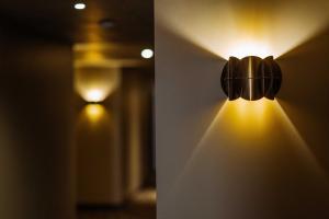 a light on a wall with lights on it at Konvin Hotel by Reykjavik Keflavik Airport in Keflavík