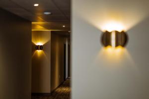 a hallway with two lights on the wall at Konvin Hotel by Reykjavik Keflavik Airport in Keflavík
