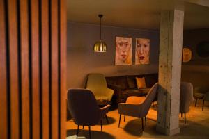 a living room with a couch and chairs at Konvin Hotel by Reykjavik Keflavik Airport in Keflavík
