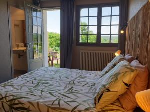 Un pat sau paturi într-o cameră la Auberge du Bois de l'étang - Motel les Tilleuls