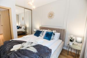 Ένα ή περισσότερα κρεβάτια σε δωμάτιο στο M&K Apartamenty Amber Delux, Gdańsk - Wyspa Sobieszewska