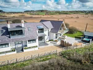 an aerial view of a house with a fence at Glan Towyn in Holyhead