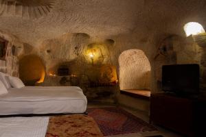 Kama o mga kama sa kuwarto sa Cave Art Hotel Cappadocia