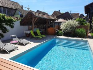 a small swimming pool with chairs and a gazebo at Oasis d'Alsace in Valff