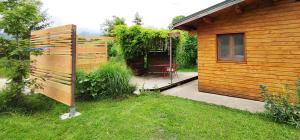 a backyard with a wooden house and a patio at Gîtes Vu d'Ici in La Chapelle-en-Vercors