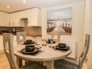 a kitchen and dining room with a table and chairs at Harbour Cottage in Torquay
