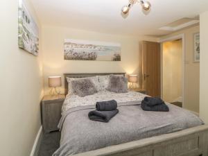 a bedroom with a bed with two pillows on it at Harbour Cottage in Torquay