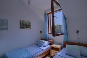 a bedroom with two beds and a window at Apartments Matijasevic in Korčula +84 photos