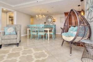 a dining room with a blue table and chairs at Anglers Cove 608 in St Pete Beach