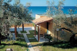 a house with a patio and the ocean in the background at Apulia Europe Garden Eco&Sport resort in Silvi Marina