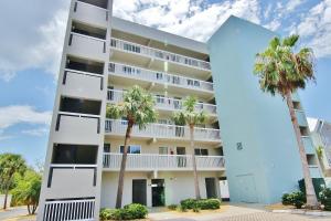 a building with palm trees in front of it at Water View 506 in Clearwater Beach