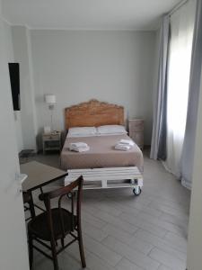 a bedroom with a bed and a table and a desk at " DOMUS CORALLA" BnB Racconti Di Viaggio in Catania
