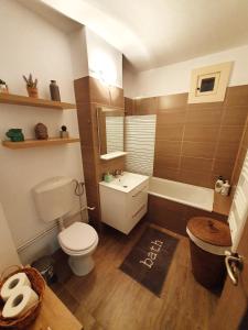 a bathroom with a toilet and a sink and a tub at SeaLover Apartment in Constanţa