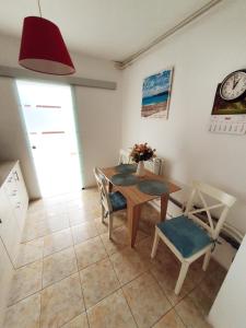 a dining room with a table and chairs and a clock at SeaLover Apartment in Constanţa