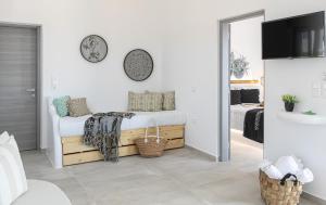a white bedroom with a bed and a mirror at Villa Oceana in Mikri Vigla