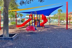 a playground with a slide in a park at Royal Orleans 111 in St Pete Beach