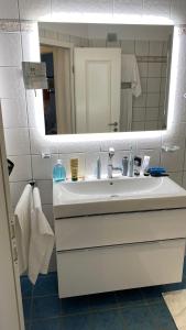 a bathroom with a white sink and a mirror at Landhaus am Haff A9 in Stolpe auf Usedom +20 photos