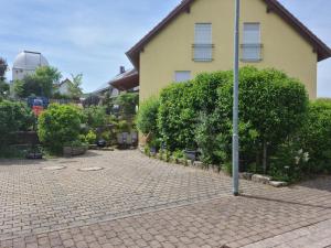 a pole on a brick street in front of a house at Exclusive cozy apartment in the heart of Franconia in Gaukönigshofen