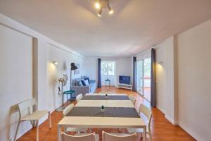 a dining room with a long table and chairs at Nura Houses Duplex Magaluf 2 in Magaluf