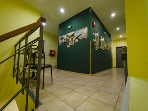 a hallway with a staircase and a green wall at RentRooms Thessaloniki in Thessaloniki