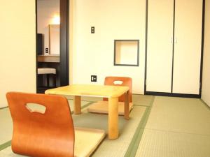 a table and two chairs in a room at HOTEL LiVEMAX Osaka Namba in Osaka