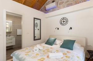 a bedroom with a bed with towels on it at PERLA - small comfy house with the terrace in Prožura