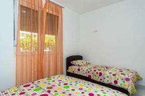 a bedroom with two beds and a window at Apartments Ivana in Bar