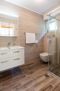 a bathroom with a sink and a toilet at PERLA - small comfy house with the terrace in Prožura