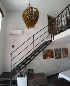 a spiral staircase in a living room with a chandelier at Casa Da Cabeça in Faro