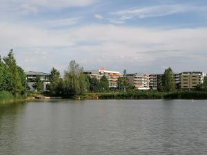 a large body of water with buildings in the background at Appart-Hôtel Mer & Golf City Bordeaux - Bruges in Bruges