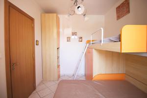 a small room with a bunk bed and a closet at Villetta Rosetta by RENTHOUSESALENTO- a 100 m dal mare in San Foca