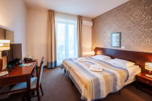 Posteľ alebo postele v izbe v ubytovaní Hotel Kuracyjny Spa & Wellness + 37 fotografií