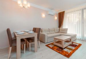 a living room with a couch and a table at Harmony Suites - Dream Island in Sunny Beach