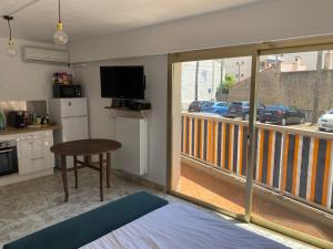a room with a kitchen and a balcony with a view at Studio Palm Beach Cannes in Cannes