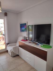 a living room with a large flat screen tv at Mojacar a in Mojácar +32 photos
