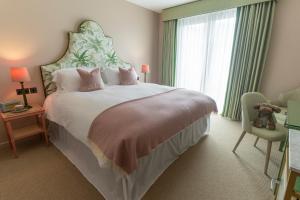 a bedroom with a large bed with a large window at Oyster House in The Mumbles