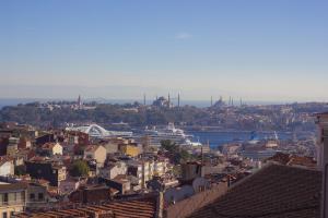 a view of a city with a cruise ship in the water at Taksim Prelude Hotel in Istanbul