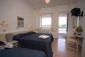 Postel nebo postele na pokoji v ubytování Hotel Dino