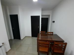 a dining room with a table and four black doors at salta centro in Salta