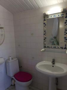 a bathroom with a toilet and a sink at Résidence Naturelle pour Naturistes in Le Moule