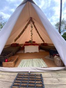 a tent with a bed and a table in it at "Exclusive" Glen Farm Glamping in Cromer